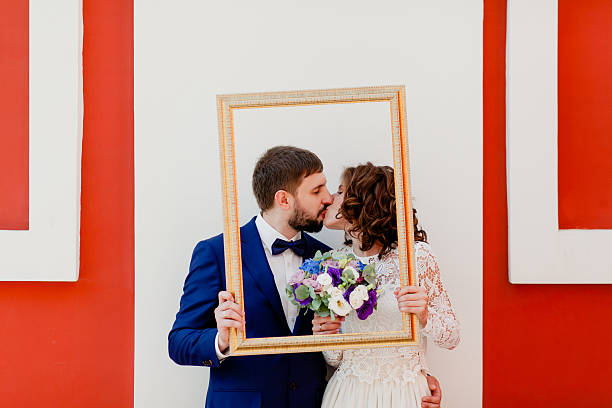 Bride and groom with a frame stock photo