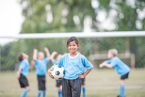 istock Young Girl Playing Soccer 607917186