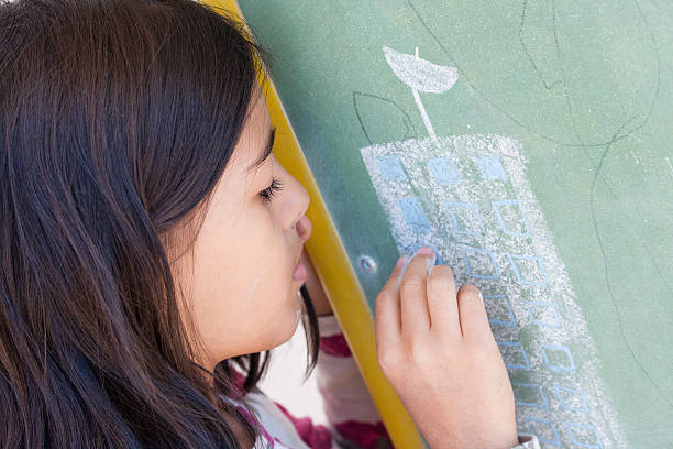 istock Girl draws in chalkboard 607918528