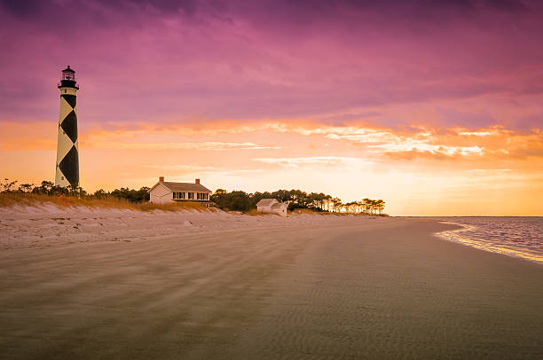 Cape Lookout at Sunset A view of the Cape Lookout lighthouse just before sunset. outer banks north carolina stock pictures, royalty-free photos & images
