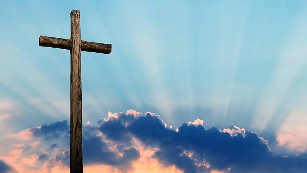 istock Christian cross over beautiful sky 607918694