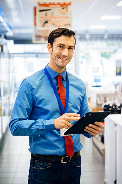 Sales clerk doing online order with tablet pc stock photo