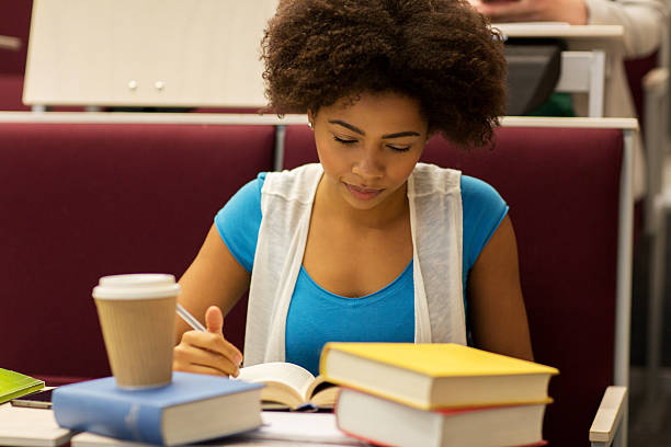 istock student girl with books and coffee on lecture 607918892