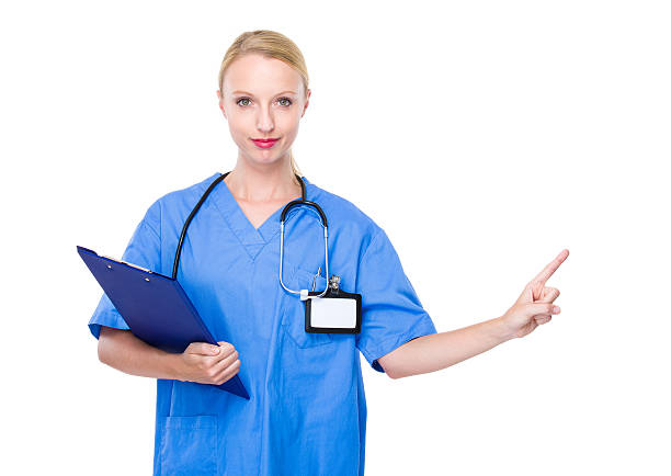 istock Female doctor holding a clipboard and pointing 607918988