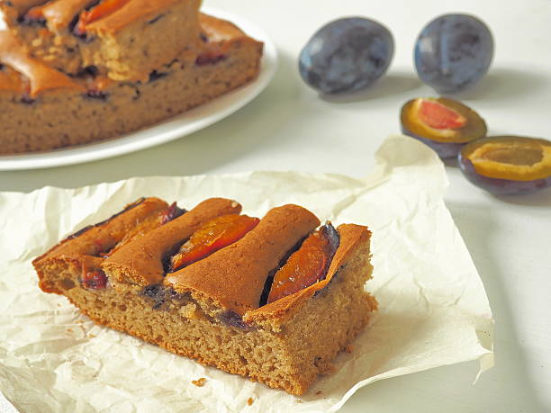 istock Slice of plum pie close up 607920024