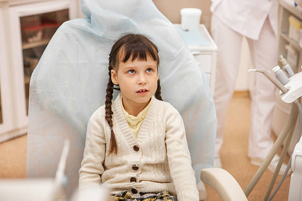 istock Girl at the dentist. 607920032