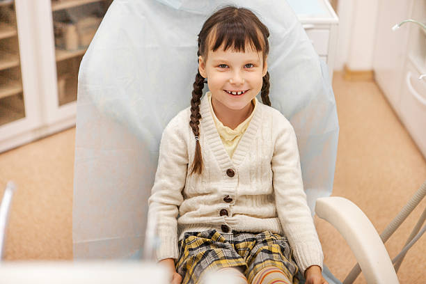 istock Girl at the dentist. 607920330