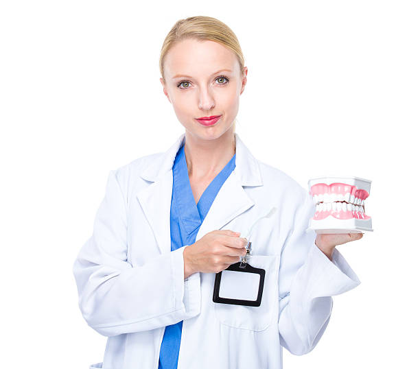 istock Female dentist holding dentures 607920648