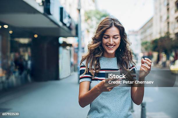 Attractive Young Woman Texting On The Street Stock Photo - Download Image Now - Mobile Phone, Teenage Girls, Telephone