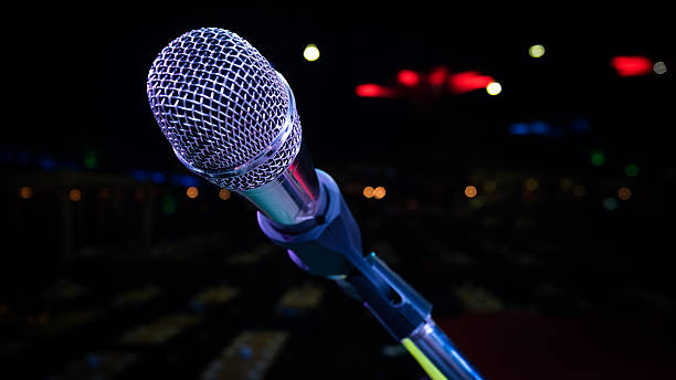 istock microphone stand on the stage venue with blur bokeh background 607922960