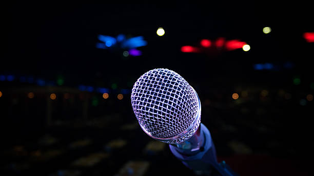 istock microphone stand on the stage venue with blur bokeh background 607923014