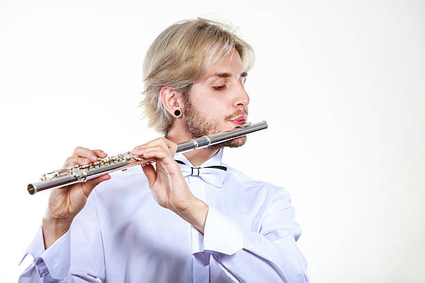 istock Male flutist playing his flute 607926386