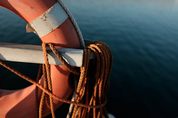 istock old life buoy in harbour. 607926770