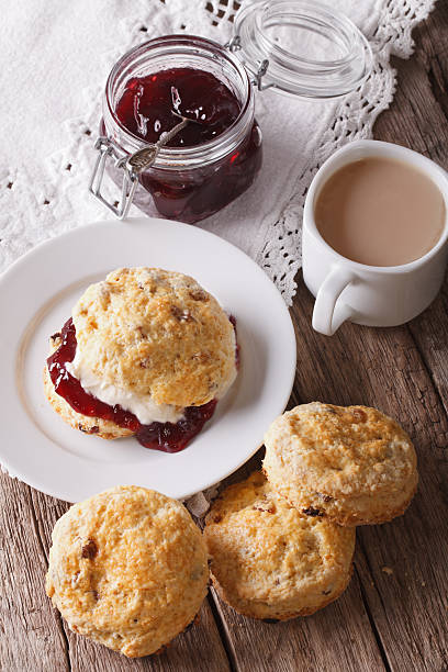 istock Homemade buns with jam and tea with milk close-up. Vertical 607926966