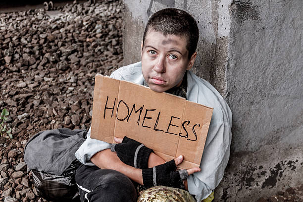 istock Homeless poor woman with sign 607927430