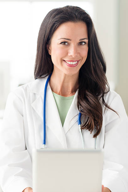 istock Young Woman Doctor Nurse with Digital Tablet 607929320