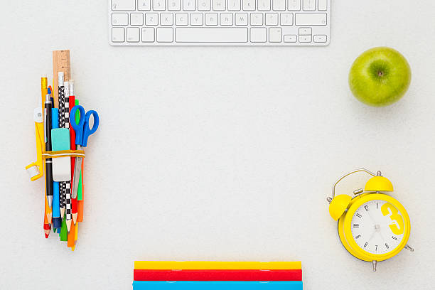 istock School supplies, keyboard, alarm clock and apple with copy space. 607929704