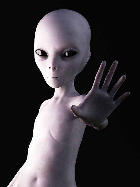 3D rendering of an alien. Alien holding its hand up like it's greeting you. 3D rendering. Black background. grey alien stock pictures, royalty-free photos & images