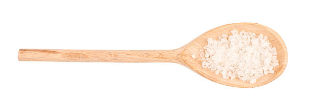 istock sea salt on wooden spoon isolated on white background 607960052