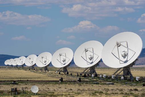 a row of satellite dishes at the Very Large Array near Socorro, New Mexico