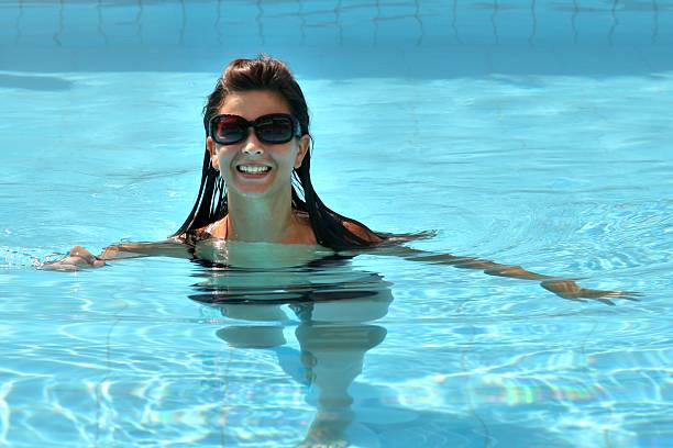 istock attractive girl in a swimmingpool, 607960980