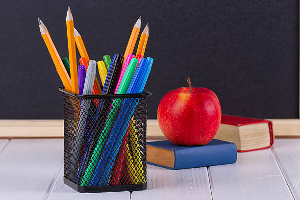istock Background blackboard chalk, books, pencils and apple 607962114