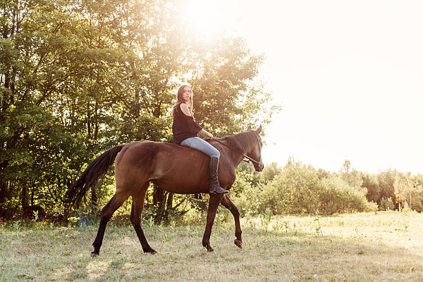 istock Woman riding a horse 607963804