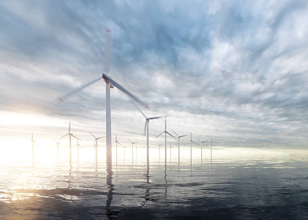 istock Offshore wind power plants with sunset stormy sky in background 607964536
