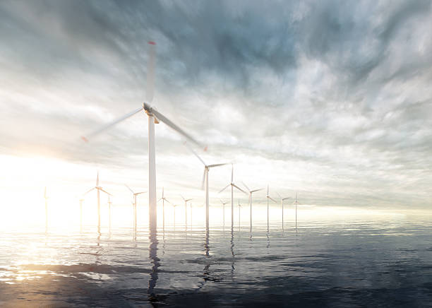 istock Offshore wind turbines with sunset stormy sky in background 607966038