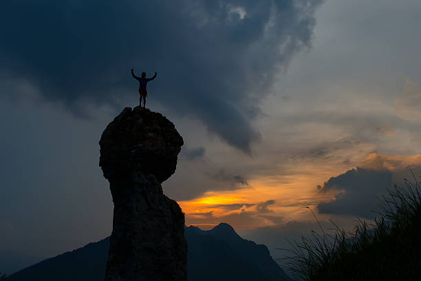 istock Man conquers the top of a mountain 607973152