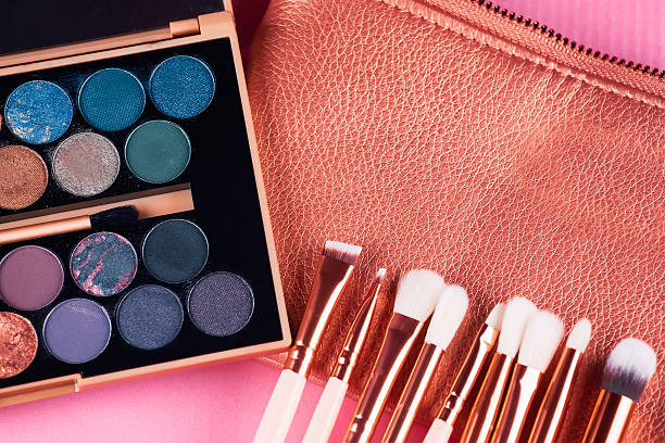 istock Face makeup brushes on pink and brown background. 607973196