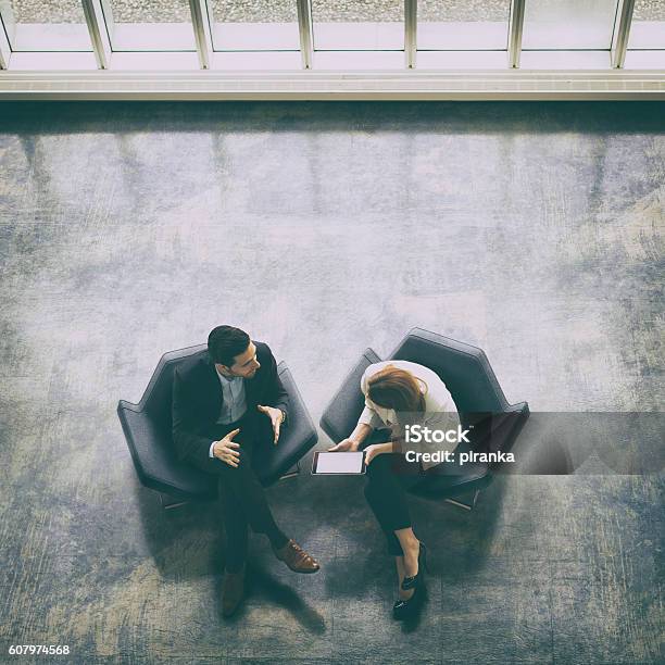 Overhead View Of Two Business Persons In The Lobby Stock Photo - Download Image Now - Business, Partnership - Teamwork, Meeting