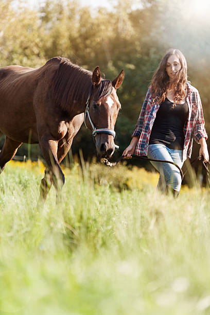 istock Woman with her horse 607976270