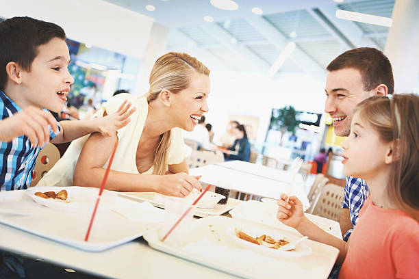 istock Family having enjoyable lunch at a restaurant. 607977206