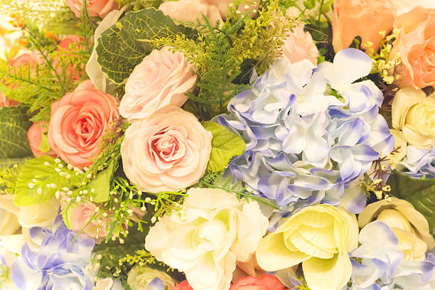 istock Beautiful multicolored artificial flowers background. flowers decor. 607978554
