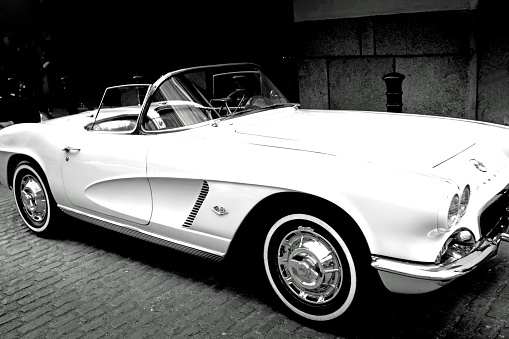 London, UK - May 1, 2016: Black and white image of a vintage Chevrolet corvette convertible in white with white wall tyres.