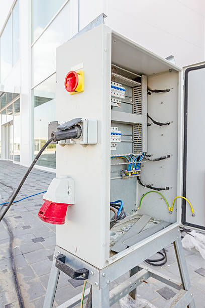 istock Extension cord is plugged in the socket of fuse box 607980898