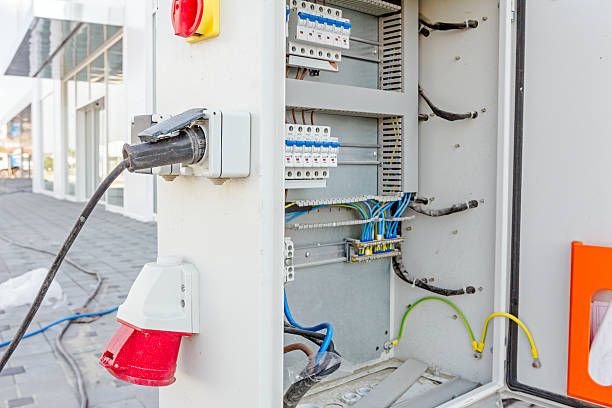istock Extension cord is plugged in the socket of fuse box 607982234