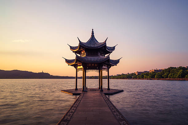 istock chinese ancient pavilion with sunset at the west lake 607985602
