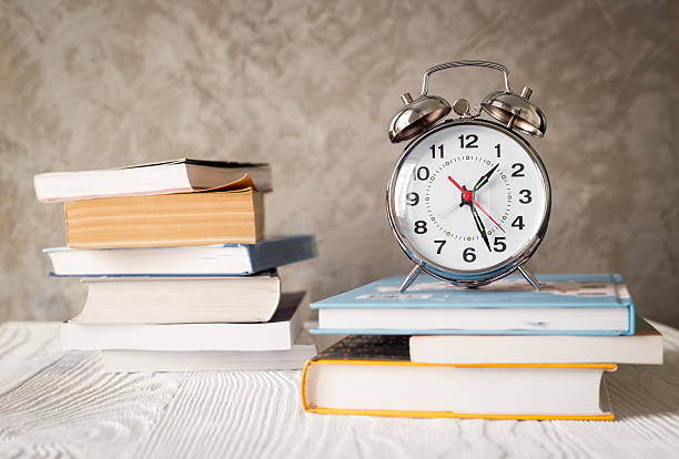 istock alarm clock time to study with books 607989538