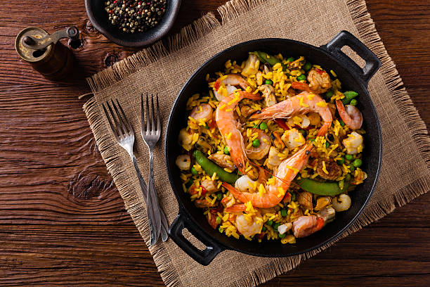 Traditional Spanish paella with seafood and chicken. Traditional Spanish paella with seafood and chicken. Prepared in wook. Top view. Seafood Paella stock pictures, royalty-free photos & images