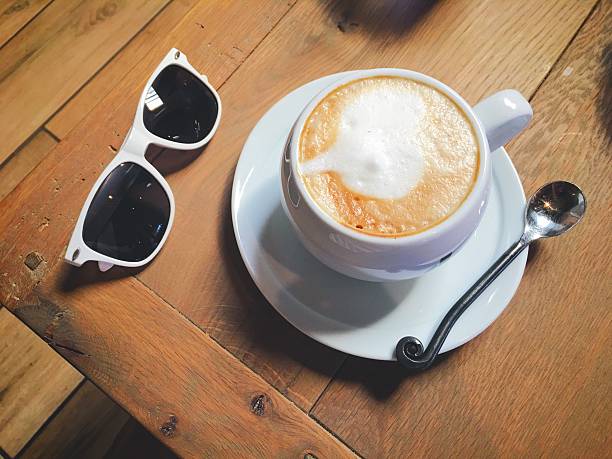 Coffee and Sunglass on a wood table