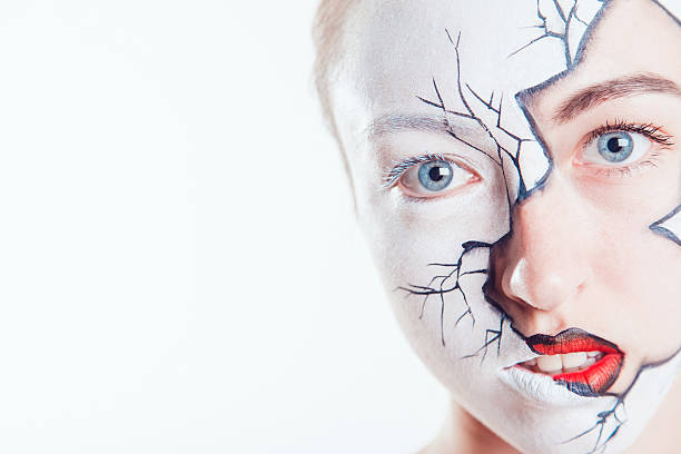 istock Girl with Halloween face art on white background 607992948