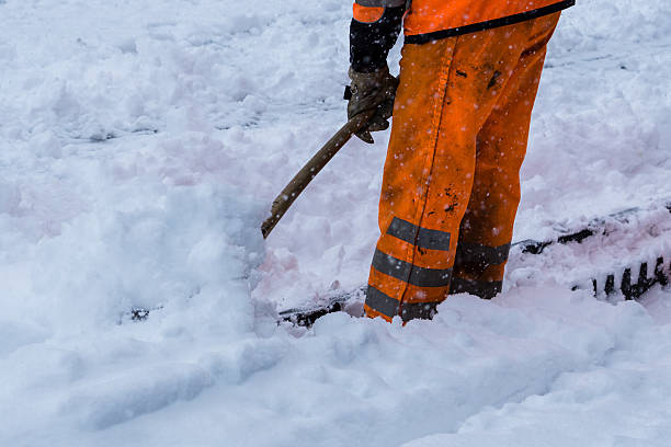 istock Workers sweep snow from road in winter 607995048
