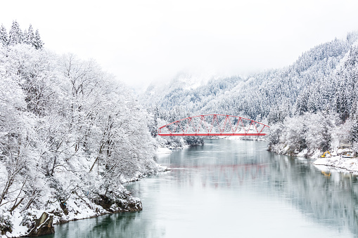 Red Bridge with winter landscape along Tadami River in Fukushima Japan