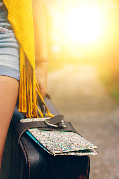 istock hand holding a suitcase with map,travel concept sun 607998232