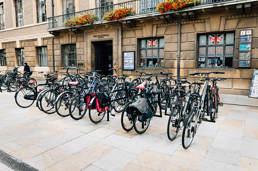 Cambridge, United Kingdom - August 11, 2015: Parking for Bicycles in Cambridge with steel bars to lock bikes to. Cambridge is a university city and one of the top five universities in the world.