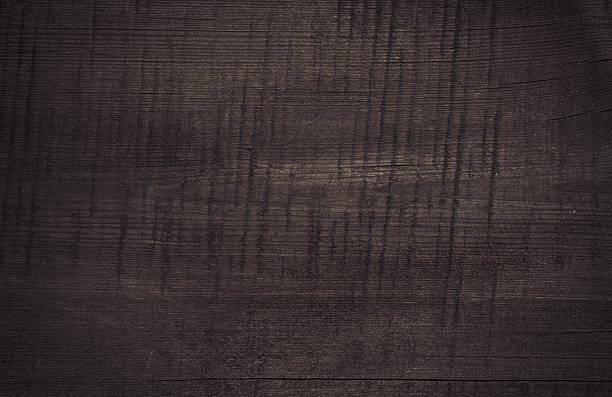 istock Dark scratched wooden cutting board wall texture 608001528