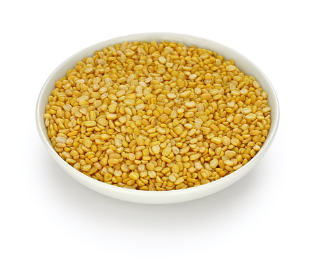 yellow moong dal, skinned and split mung bean in a small dish