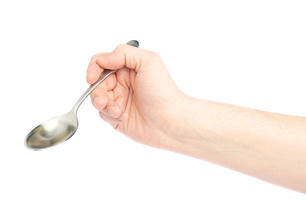 istock Male hand holding a spoon with oil 608003832